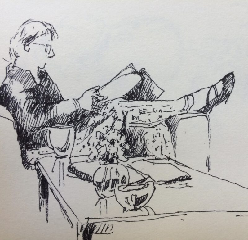 Snel geschetste pentekening van Jeroen Coenders waarop een persoon ontspannen zit te lezen met de benen omhoog achter een tafel.
